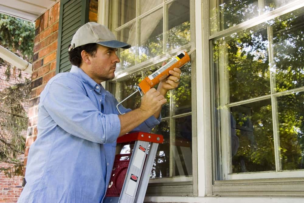 Contractor Performing Window Air Sealing