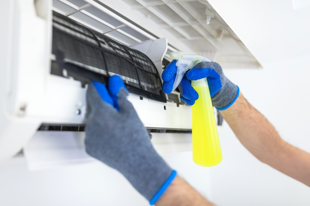 HVAC Contractor Cleaning an AC Filter