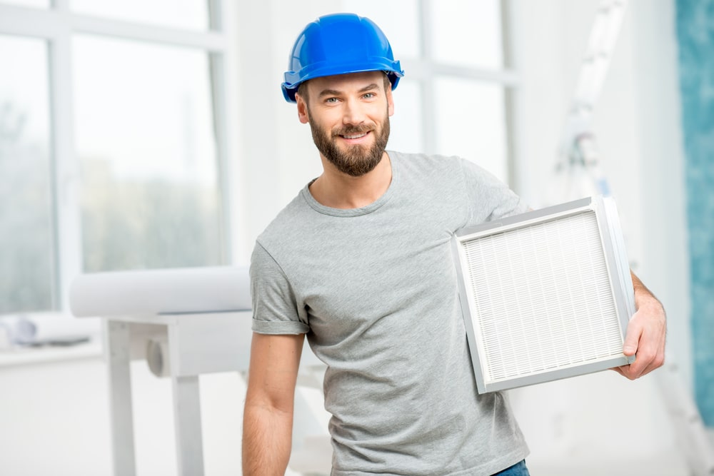 HVAC Contractor Holding a Custom AC Filter