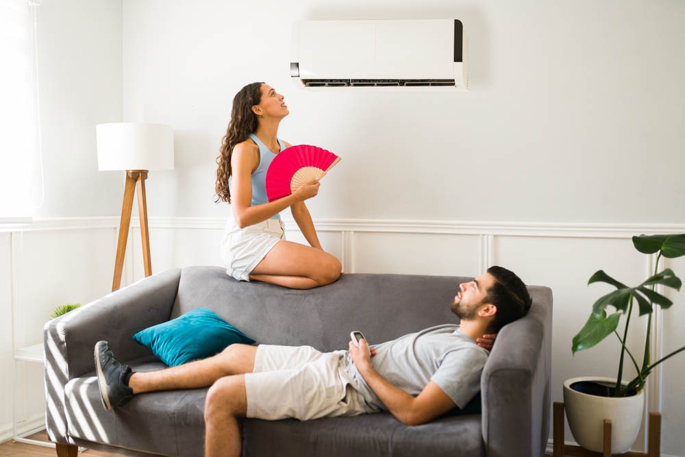 person sitting in the middle of a hot and uncomfortable living room