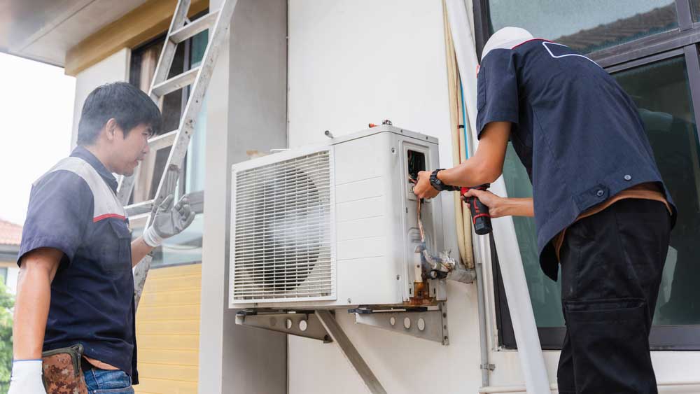 technician tinkering with an HVAC system