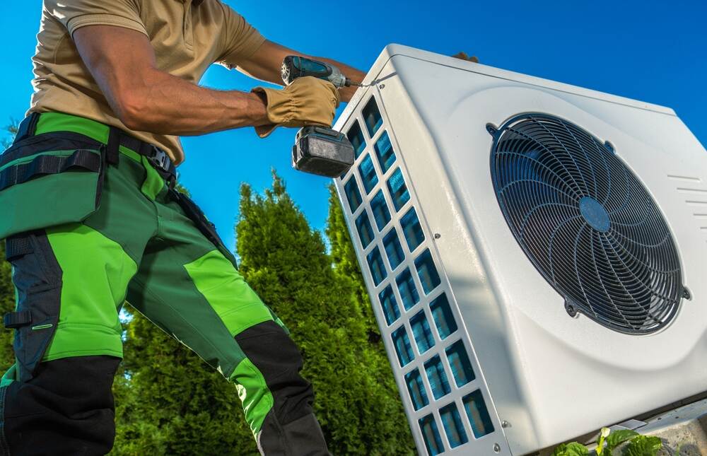 technician repairing outdoor ac unit